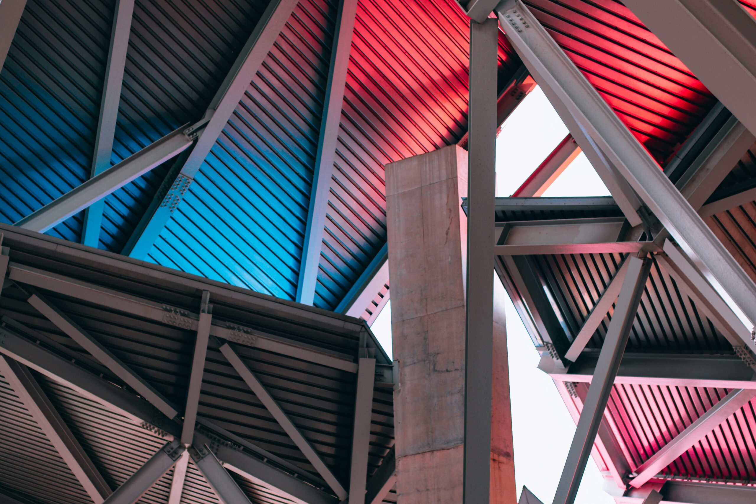 Contemporary industrial architecture with bold steel structure and vibrant lighting.